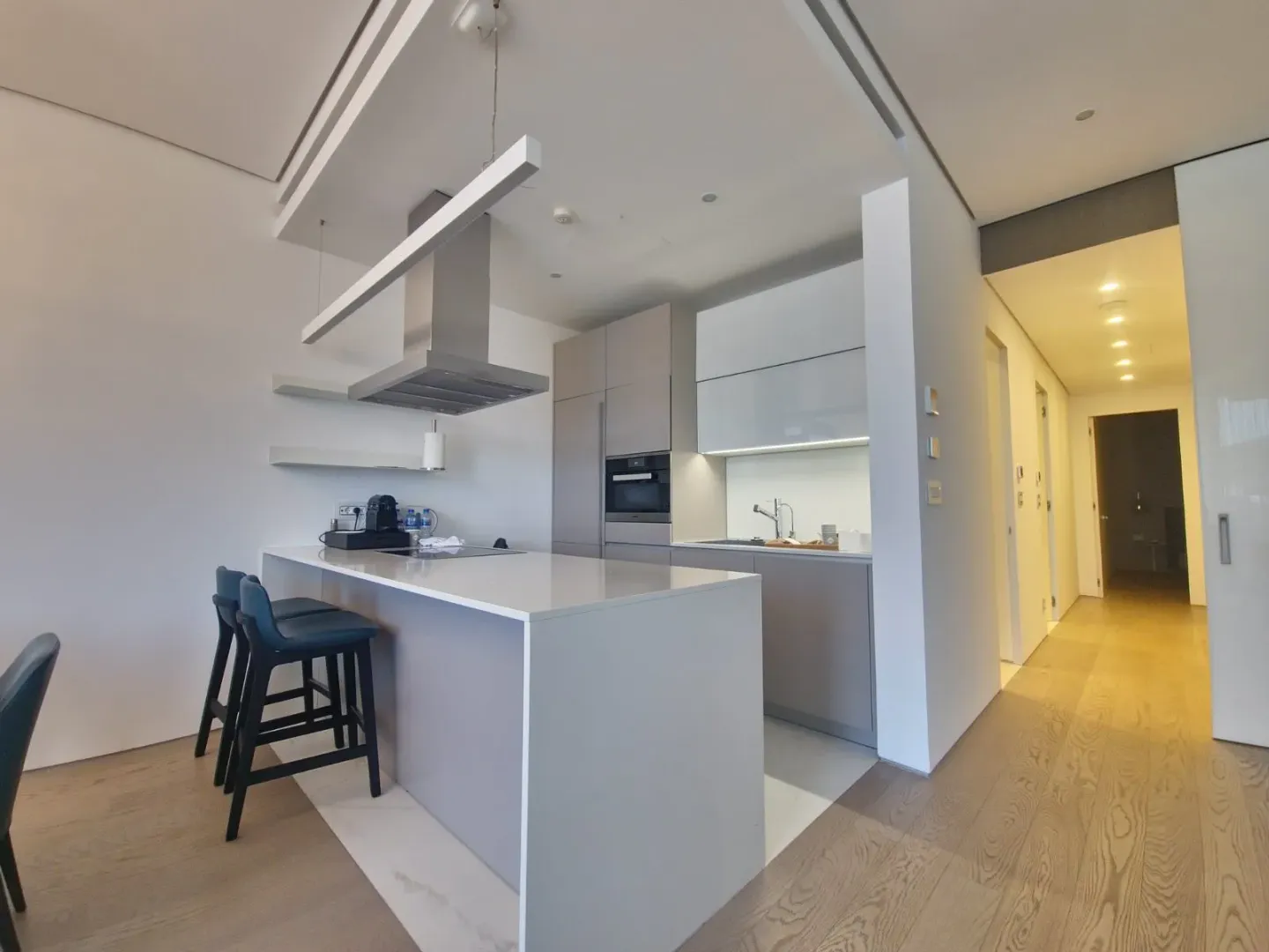 Modern kitchen with an island and bar stools.