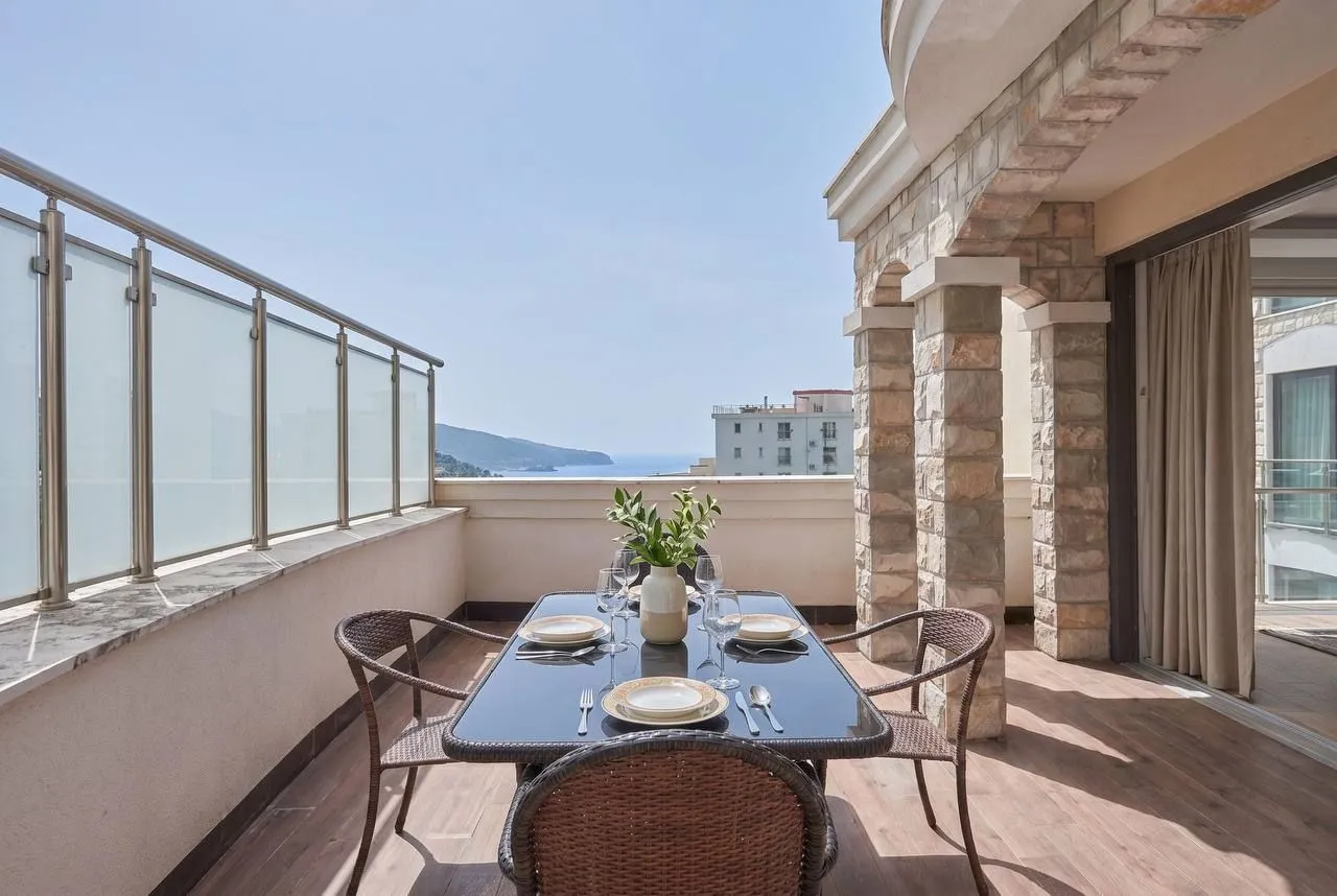 Spacious terrace with a dining table and sea view.