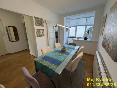 Dining area with a large table and chairs within the apartment. - image 3