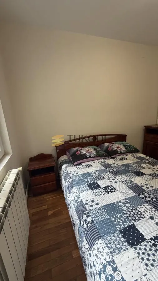 Bedroom with a double bed and a nightstand.