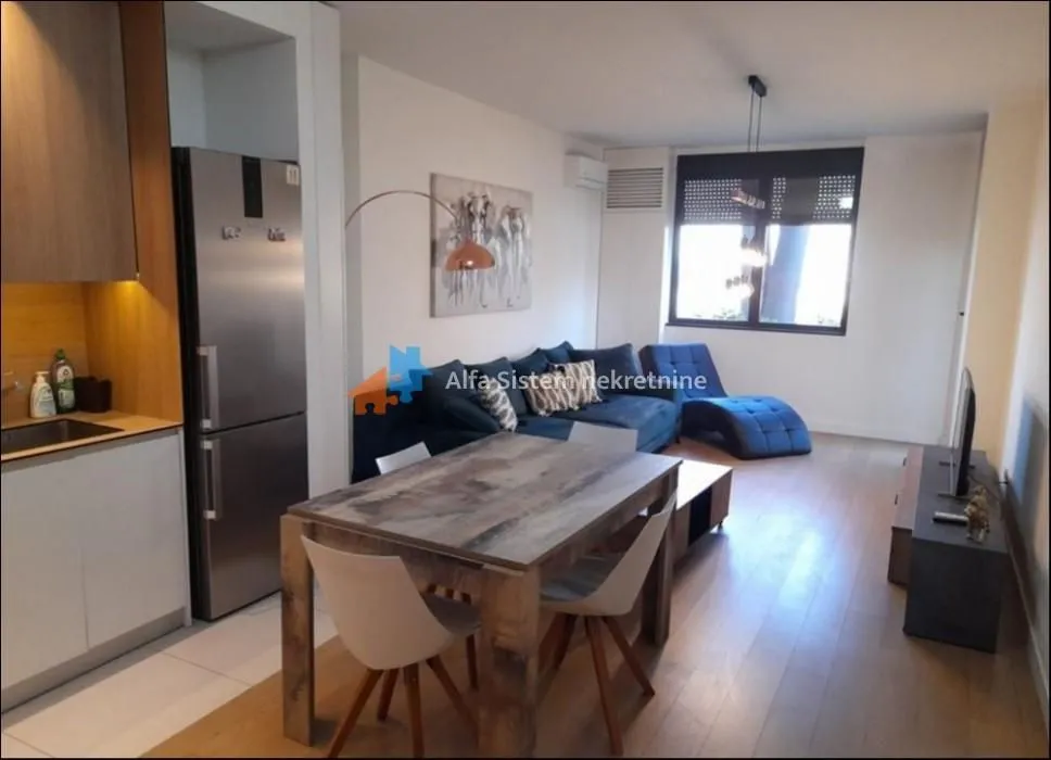 Living room with dining area and kitchen in an open space layout.