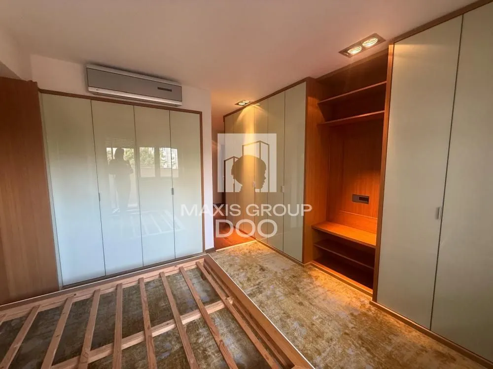 Furnished bedroom with built-in wardrobes and a double bed.