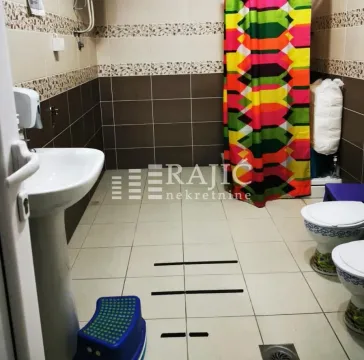 Bathroom with sink, shower and colourful curtain. - image 11