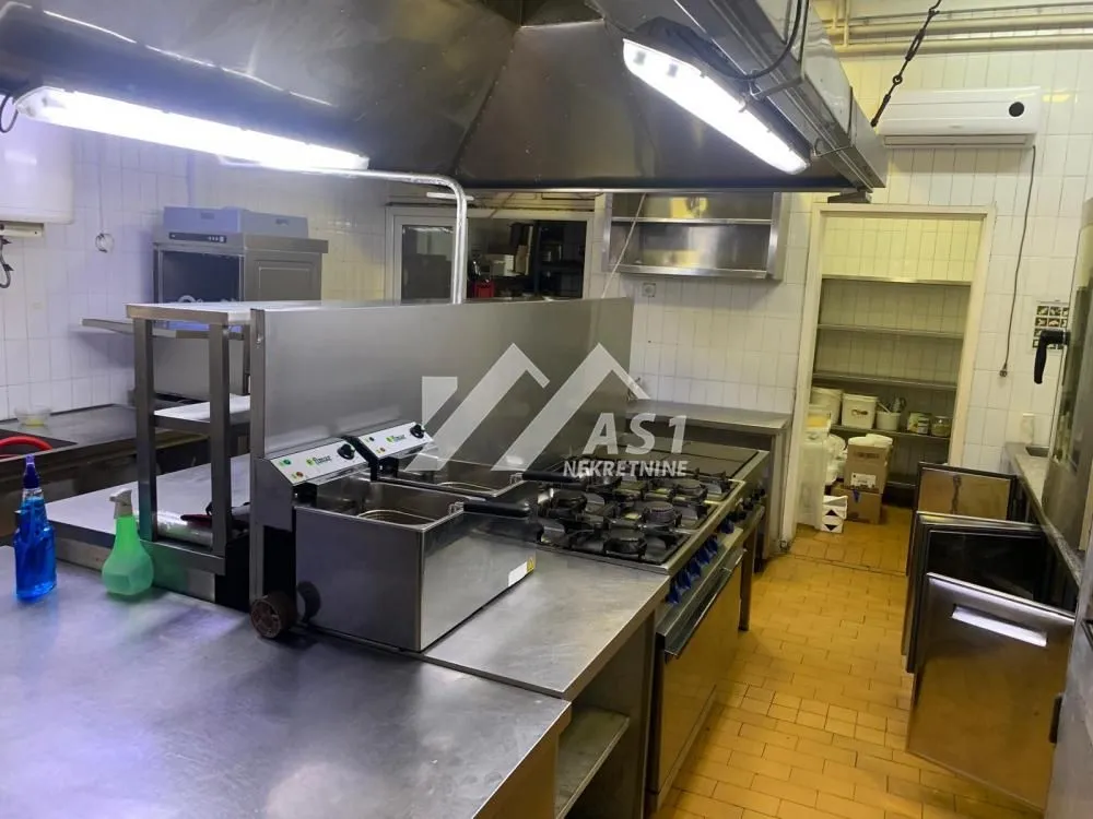Commercial kitchen with professional equipment and appliances.