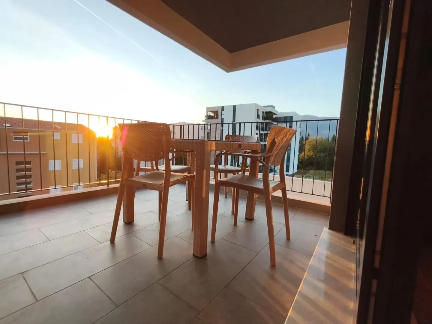 Unfurnished terrace with a table and chairs for seating.