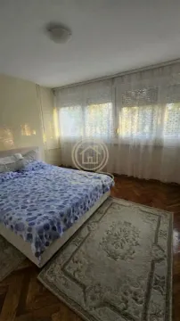 Furnished bedroom with a double bed and curtained windows. - image 2