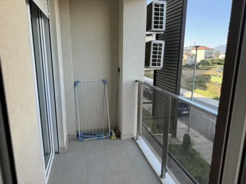 A balcony with a glass railing and an outdoor view. - image 7