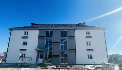 Spoljašnjost novoizgrađene stambene zgrade pod plavim nebom. - image 4