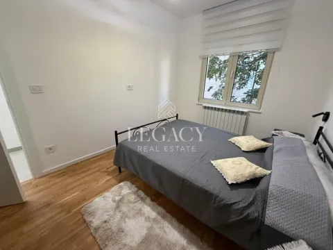Bedroom with a double bed, wooden floor, and a window. - image 18
