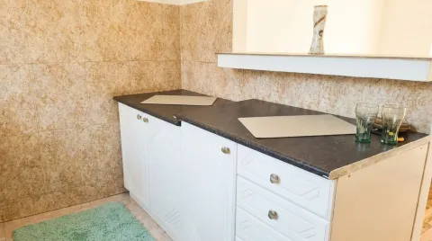Small part of the kitchen with white cabinets and dark countertop. - image 6