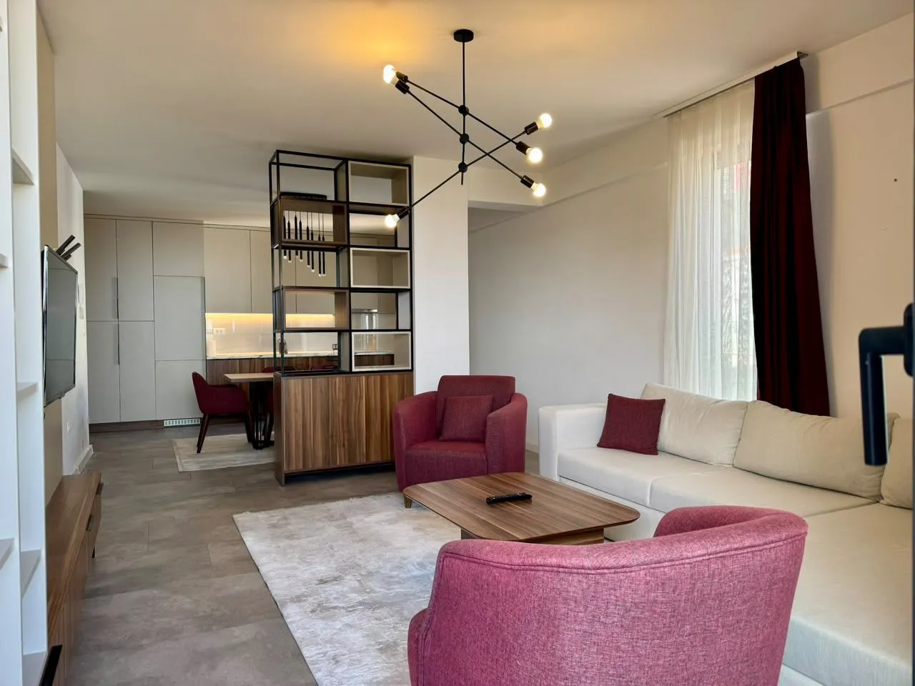 Spacious living room with a sofa set and a dining area in the background.