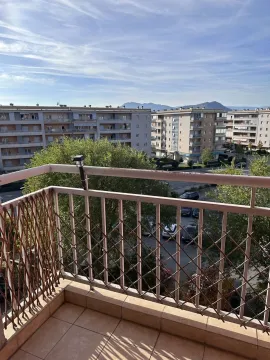 View from the balcony overlooking surrounding residential buildings and the street. - image 11