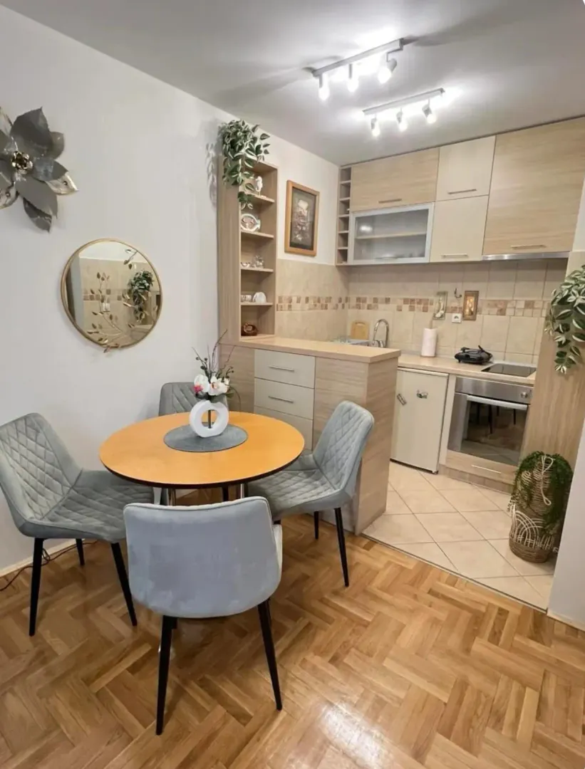 Small kitchen with a dining area and wooden elements.