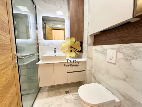 Modernly equipped bathroom with a shower cabin, washbasin, and built-in sanitary ware. - image 9