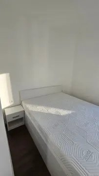Bright bedroom with a double bed and a nightstand. - image 4