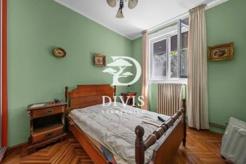 Spavaća soba sa drvenim krevetom, noćnim stočićima i zelenim zidovima. - image 5