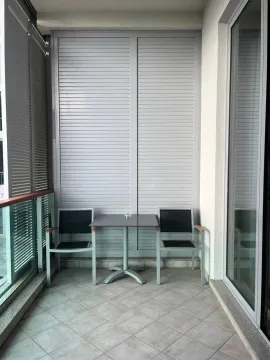 Covered terrace with a table and two chairs. - image 6
