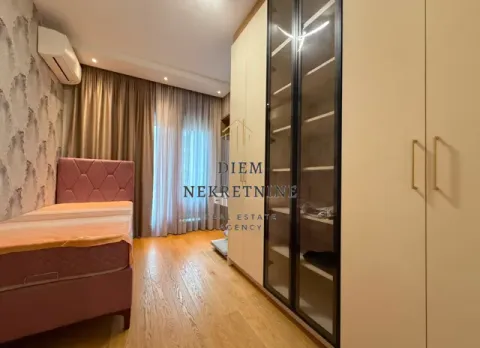 Furnished bedroom with a bed and a large wardrobe. - image 15