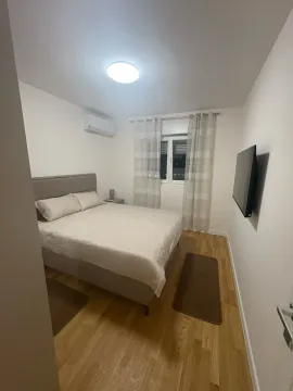 Bedroom with a double bed, air conditioning, and a wall-mounted TV. - image 22