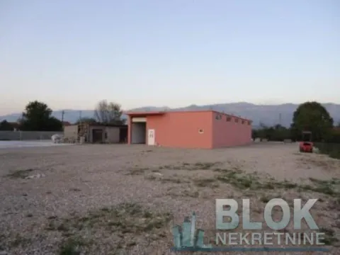 Exterior view of a single-story building with a large yard. - image 6