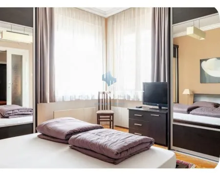 Furnished bedroom with large mirrored wardrobes and windows. - image 3