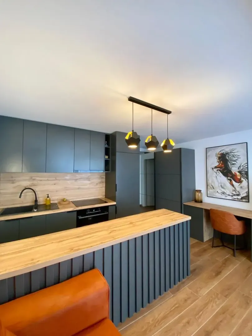 Modern kitchen with a breakfast bar and dining area.