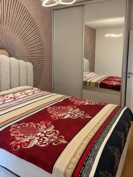 Furnished bedroom with a double bed and a built-in wardrobe with a mirror. - image 6
