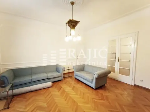 Living room with sofas, parquet flooring, and a classic chandelier. - image 12