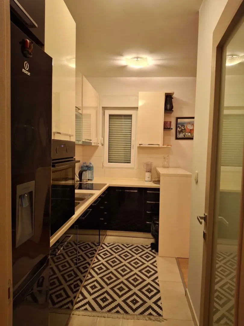 Small kitchen with black and white elements and a window.