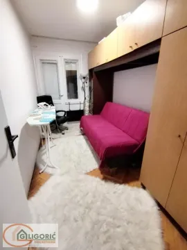 Small room with a pull-out sofa bed and fitted wardrobes. - image 6