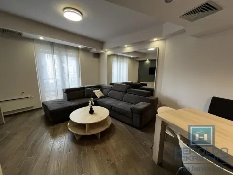 Living room with a corner sofa, coffee table, and dining table. - image 2