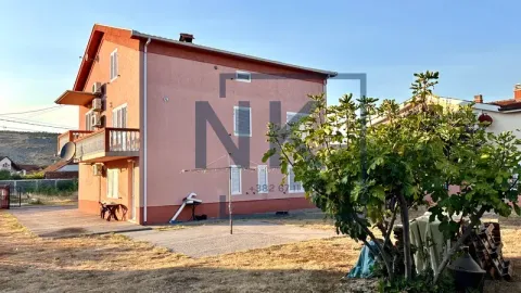 Exterior view of a three-story house with a yard and greenery. - image 4