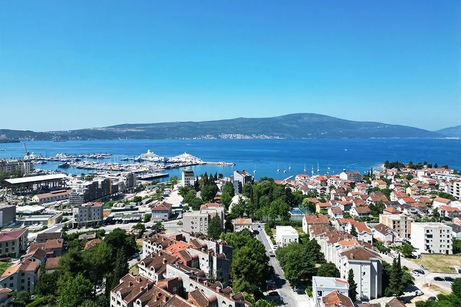 Aerial view of the town, marina, and sea.