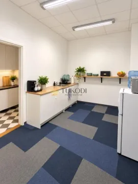 Kitchenette with sink, countertop, and shelving in an office space. - image 12