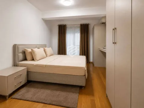 Furnished bedroom with a double bed, wardrobe, and wooden flooring. - image 6