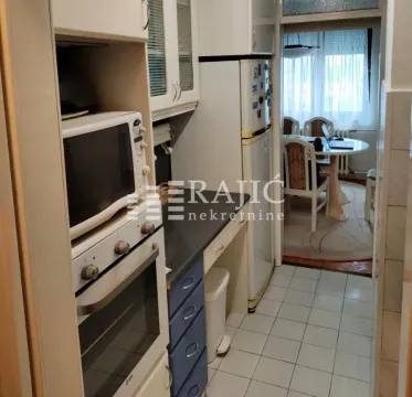View of a small kitchen with built-in appliances. - image 3