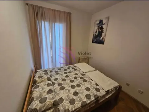 Small bedroom with a double bed, window, and an art painting on the wall. - image 4