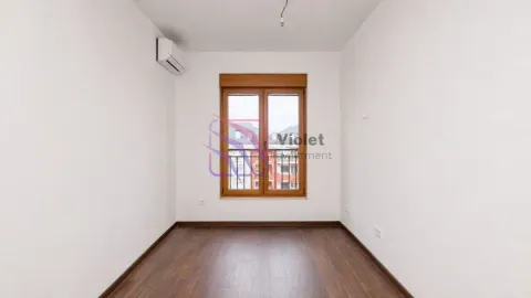 Empty room with wooden flooring, air conditioning unit, and a window. - image 5
