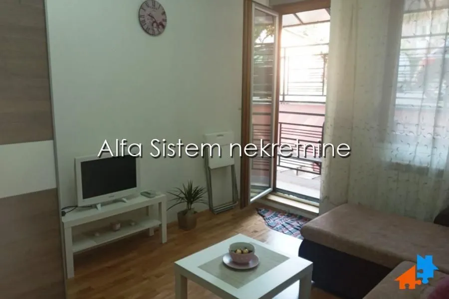 Living room with access to the terrace and a TV.