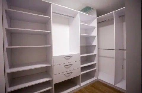 Empty white walk-in closet with shelves and drawers. - image 11