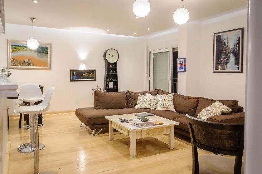 Spacious and bright living room with a sofa set and dining area.