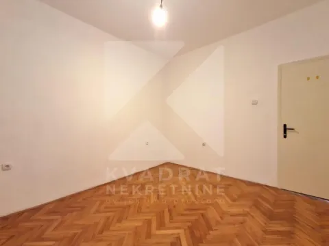 Empty room with parquet flooring and white walls. - image 17