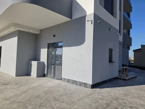 Exterior of a modern residential building with an entrance and paved yard. - image 3