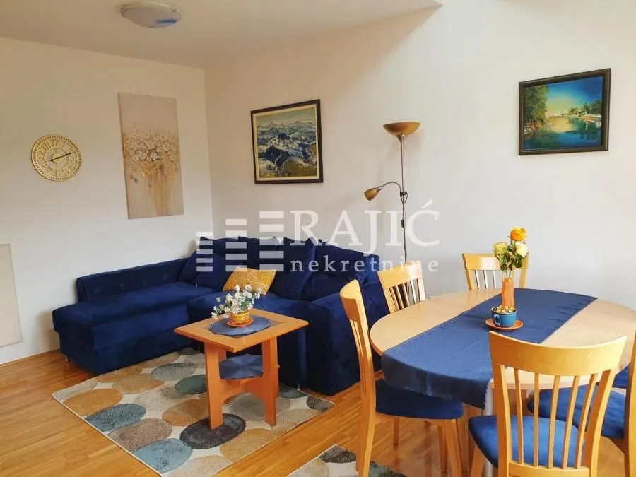 Living room with a sofa set and a dining table.