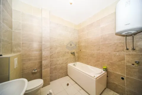 Bathroom equipped with ceramic tiles, bathtub, toilet and water heater. - image 10