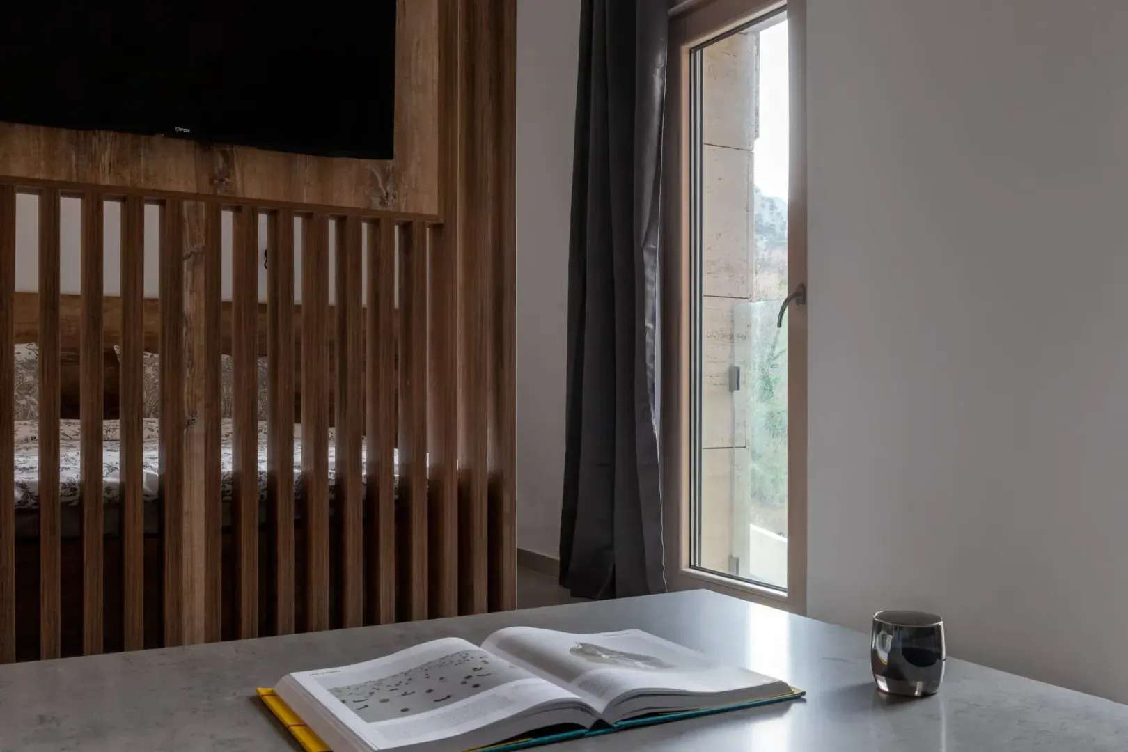 Bedroom with a wooden partition panel and a bed.