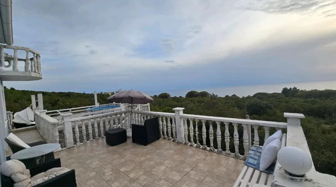 Large terrace with outdoor seating and a sea view.