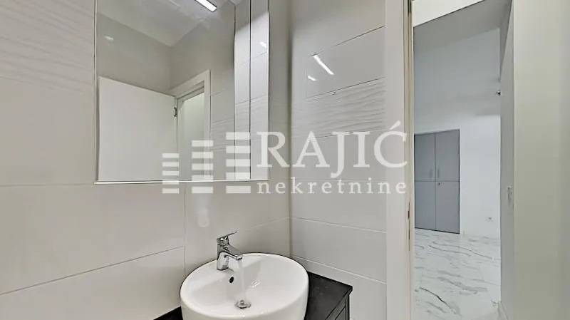 Modern bathroom with a sink and mirror.