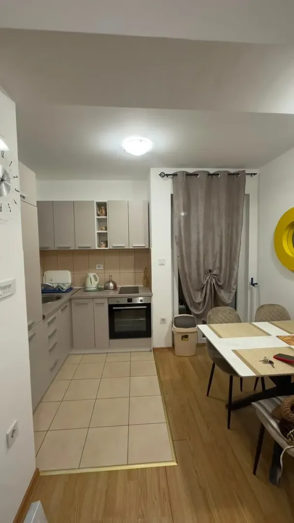 Modern kitchen with dining area and built-in appliances.