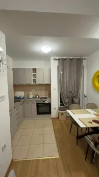 Modern kitchen with dining area and built-in appliances. - image 3